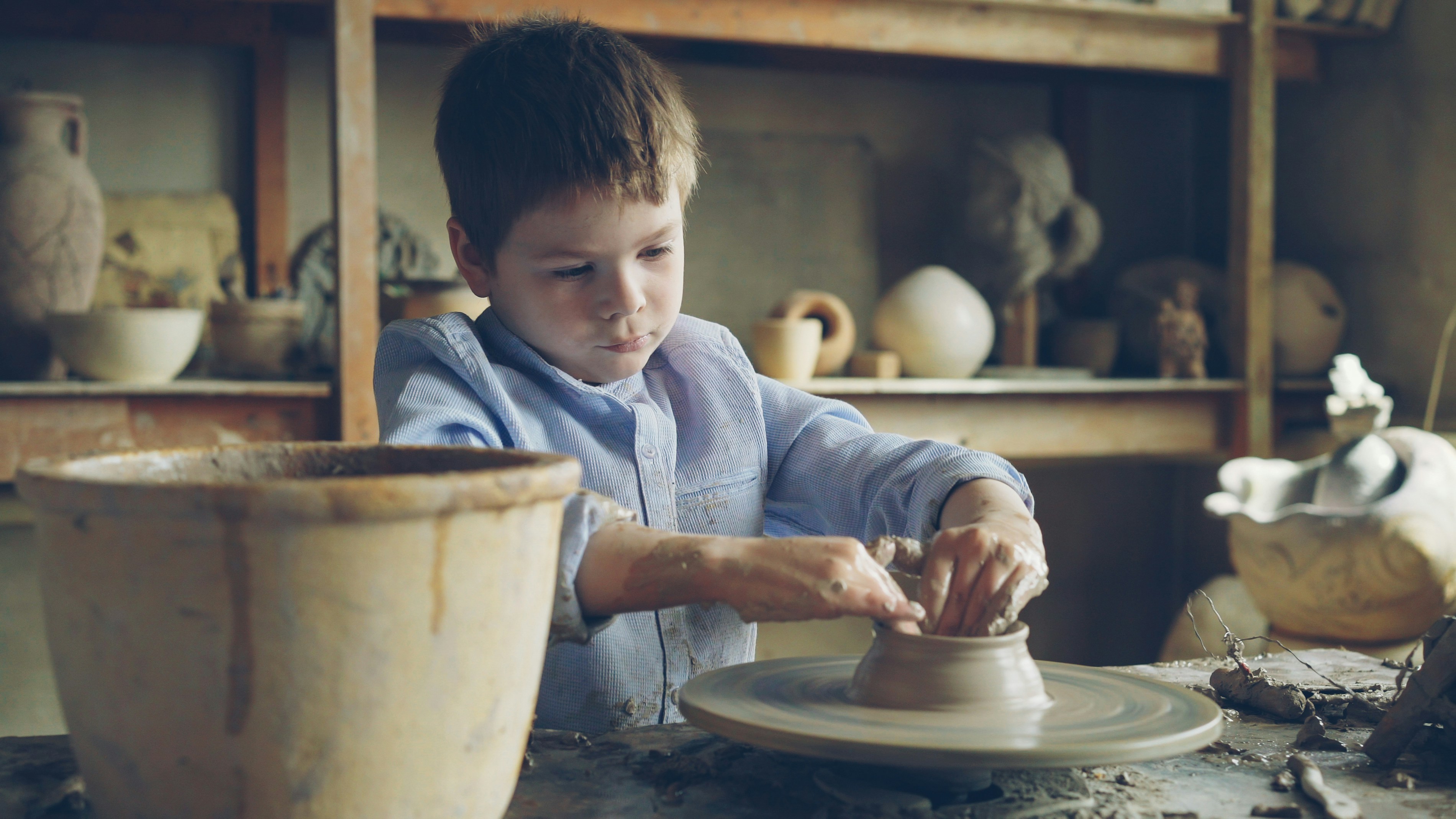 Students doing wheel throwing pottery